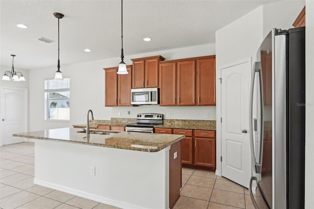 1893 Rafton Rd, Apopka, FL 32703 - kitchen featuring light tile patterned floors, visible vents, appliances with stainless steel finishes, brown cabinetry, and a sink