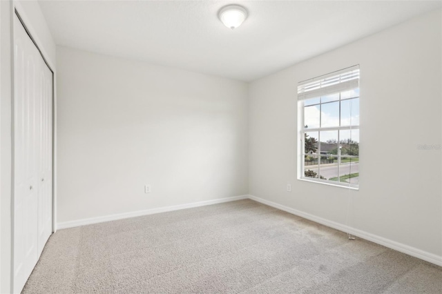 1893 Rafton Rd, Apopka, FL 32703 - unfurnished bedroom with a closet, baseboards, and carpet flooring