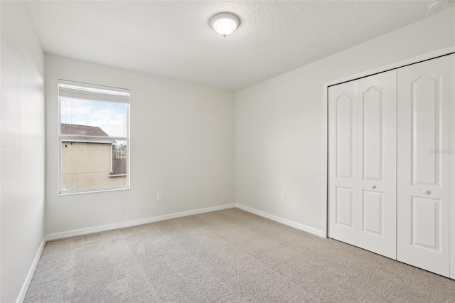 1893 Rafton Rd, Apopka, FL 32703 - unfurnished bedroom with carpet, a textured ceiling, baseboards, and a closet