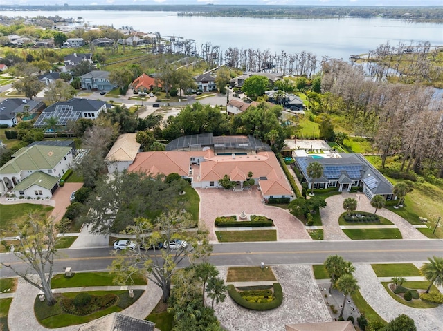 drone / aerial view featuring a water view and a residential view