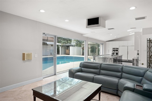 living room with lofted ceiling, baseboards, visible vents, and recessed lighting