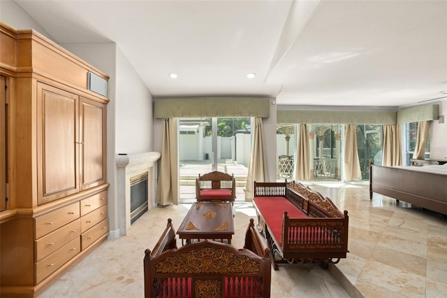 living room with a high end fireplace, plenty of natural light, and recessed lighting