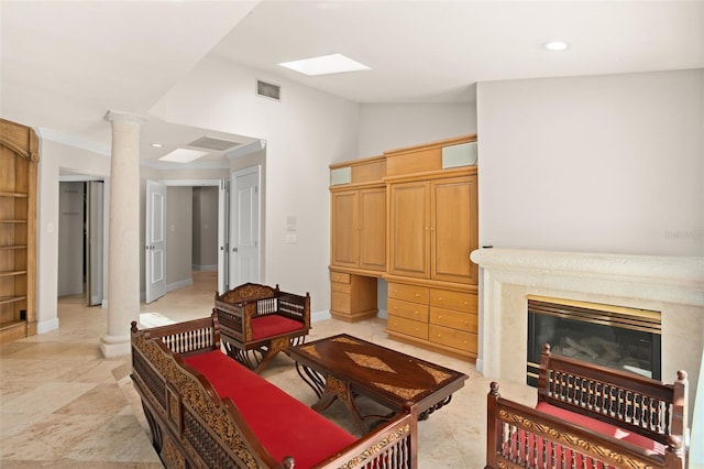 living area featuring decorative columns, visible vents, vaulted ceiling, a fireplace, and recessed lighting