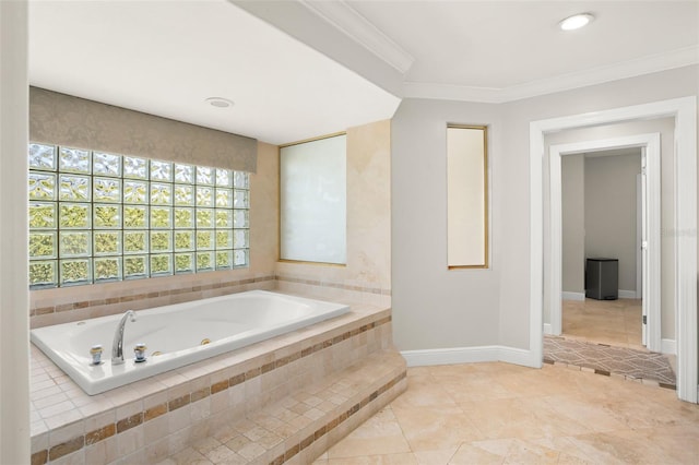 bathroom featuring baseboards, a tub with jets, tile patterned floors, and crown molding