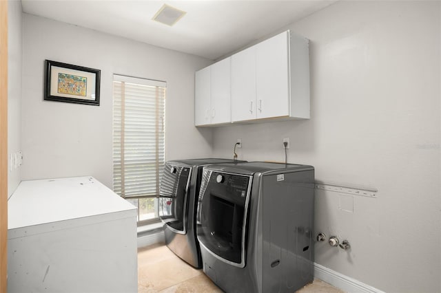 washroom with cabinet space, visible vents, baseboards, and separate washer and dryer