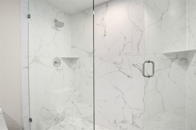 full bathroom featuring a marble finish shower