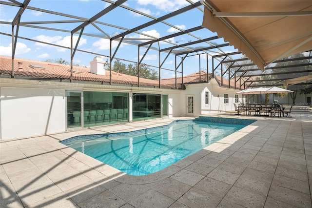 pool featuring a patio and glass enclosure