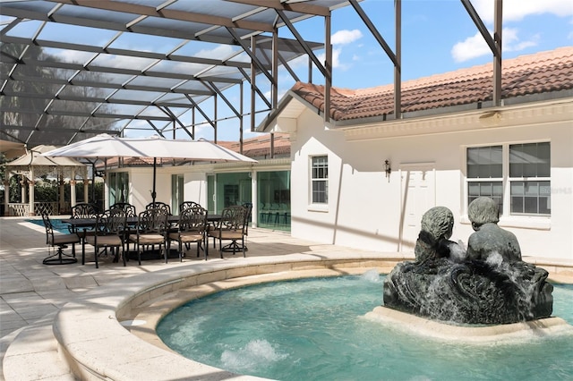 outdoor pool with outdoor dining area, a patio area, and a lanai