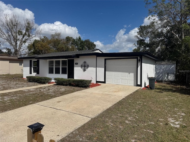 single story home featuring an attached garage, driveway, and stucco siding