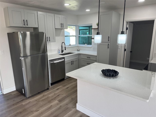 kitchen with open shelves, recessed lighting, appliances with stainless steel finishes, a sink, and light wood-type flooring