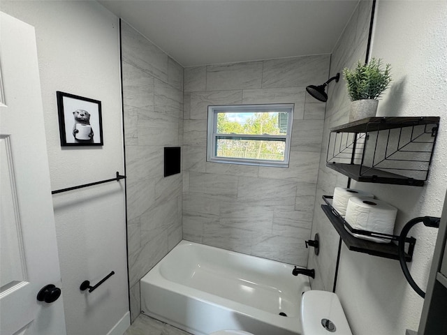 full bathroom with a textured wall and shower / bathtub combination