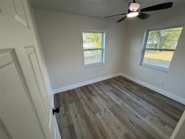 unfurnished room featuring ceiling fan, baseboards, and wood finished floors