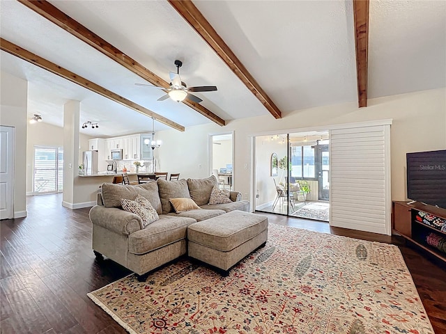 living room with dark wood-style floors, vaulted ceiling with beams, baseboards, and ceiling fan with notable chandelier