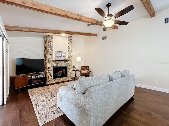 living area with dark wood-style floors, a fireplace, visible vents, beamed ceiling, and baseboards