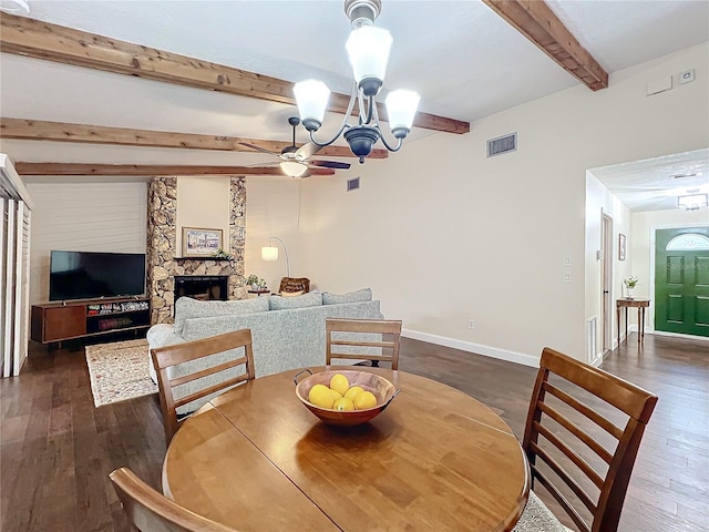 dining area with baseboards, visible vents, beam ceiling, a stone fireplace, and a notable chandelier