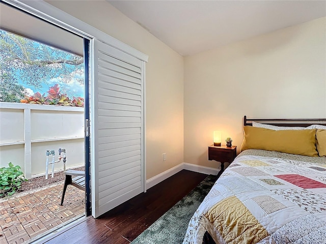 bedroom featuring baseboards and wood finished floors