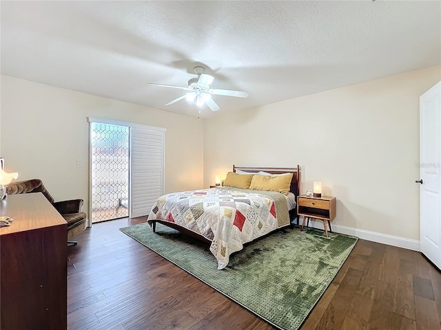 bedroom with ceiling fan, a textured ceiling, baseboards, and wood finished floors