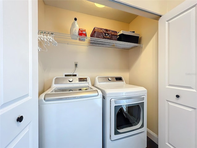 clothes washing area with laundry area and washer and clothes dryer