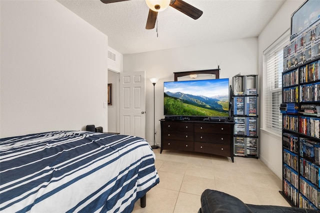 2817 Noble Crow Dr, Kissimmee, FL 34744 - tiled bedroom with a ceiling fan, visible vents, and a textured ceiling