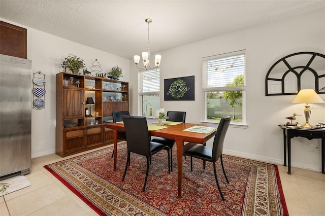 2817 Noble Crow Dr, Kissimmee, FL 34744 - dining space featuring a chandelier, baseboards, and light tile patterned flooring