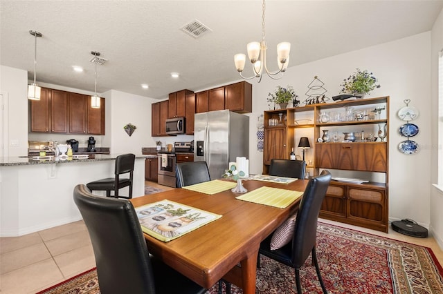 2817 Noble Crow Dr, Kissimmee, FL 34744 - dining space with an inviting chandelier, light tile patterned floors, visible vents, and recessed lighting