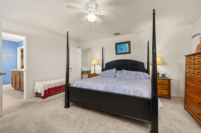 2817 Noble Crow Dr, Kissimmee, FL 34744 - bedroom with light colored carpet, ensuite bath, visible vents, ceiling fan, and baseboards
