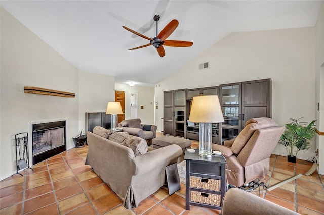 living room with high vaulted ceiling, visible vents, a fireplace, and ceiling fan