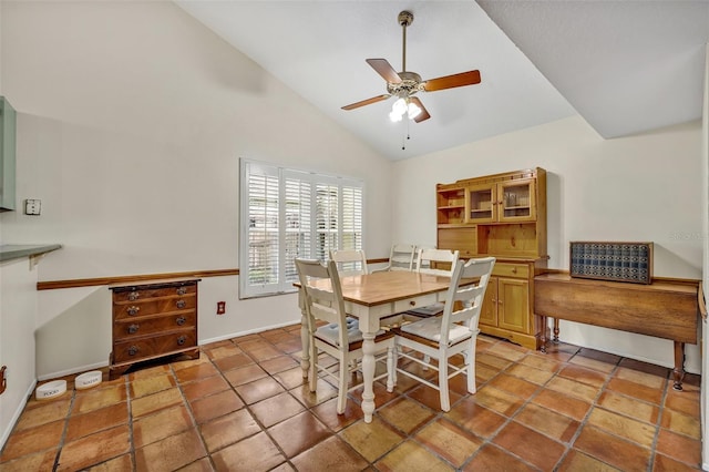 dining room featuring high vaulted ceiling, a ceiling fan, and baseboards