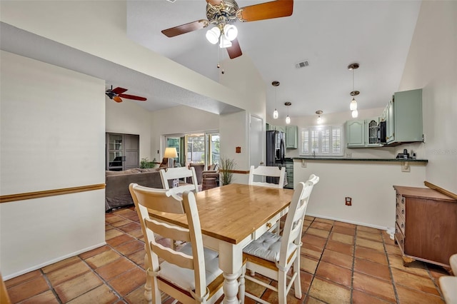 dining space featuring high vaulted ceiling, visible vents, ceiling fan, and baseboards