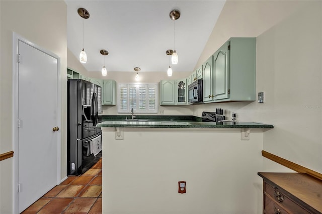 kitchen with dark countertops, black appliances, a peninsula, and green cabinetry