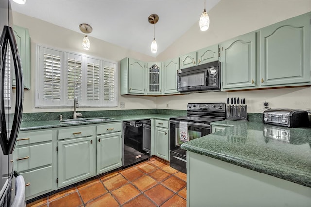 kitchen with decorative light fixtures, vaulted ceiling, black appliances, green cabinets, and a sink