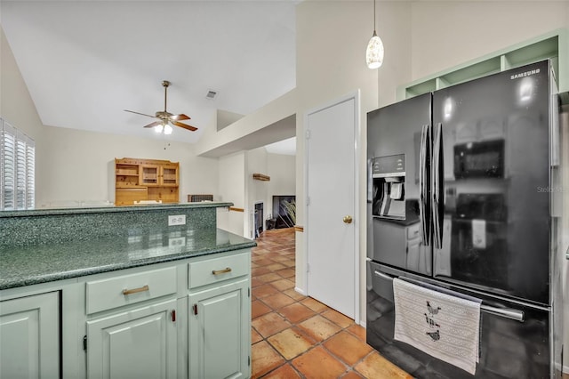 kitchen featuring light tile patterned floors, a ceiling fan, visible vents, black fridge, and green cabinetry