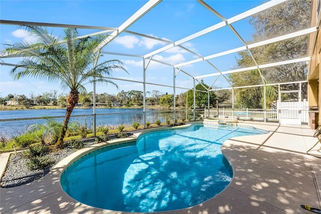 pool featuring a lanai, a patio area, and a water view