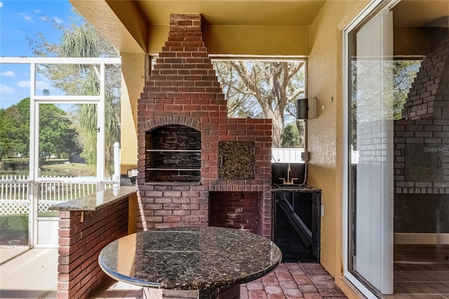 view of patio featuring an outdoor brick fireplace