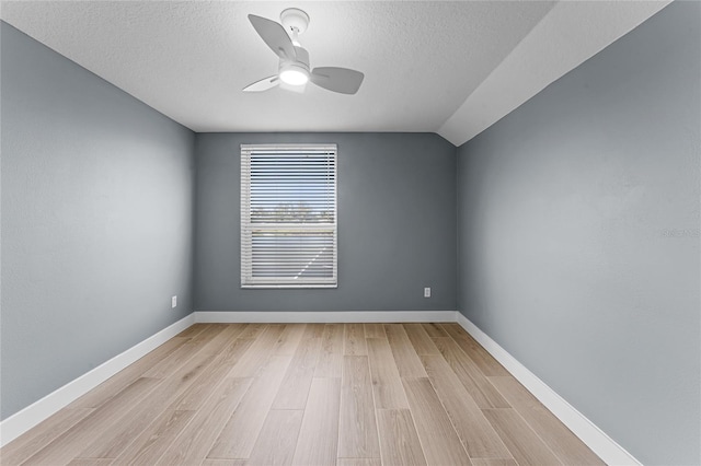 unfurnished room with baseboards, ceiling fan, a textured ceiling, and light wood finished floors