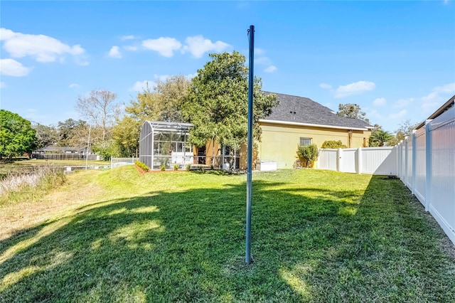 view of yard featuring a lanai and a fenced backyard