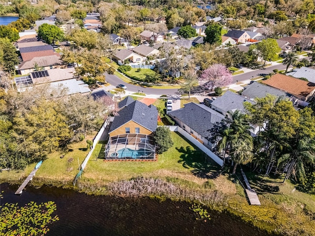 birds eye view of property with a water view and a residential view