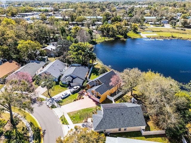 drone / aerial view featuring a water view and a residential view