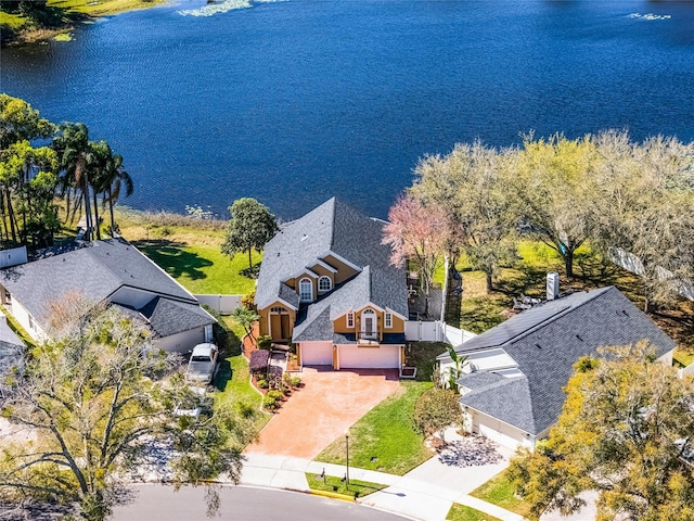 drone / aerial view with a water view and a residential view