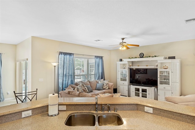 living room with ceiling fan and visible vents