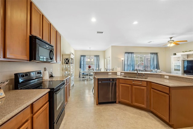 kitchen featuring brown cabinets, visible vents, a sink, and black appliances