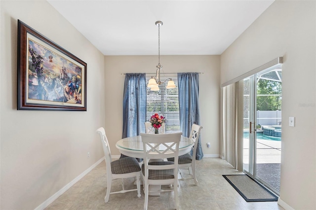 dining room featuring a chandelier and baseboards