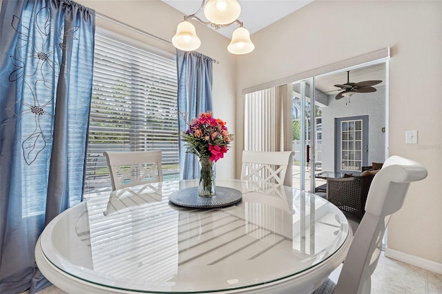 dining space with baseboards and a ceiling fan