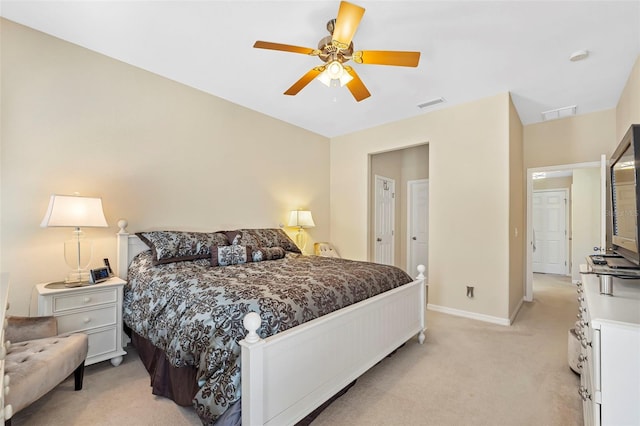 bedroom featuring a ceiling fan, light carpet, visible vents, and baseboards