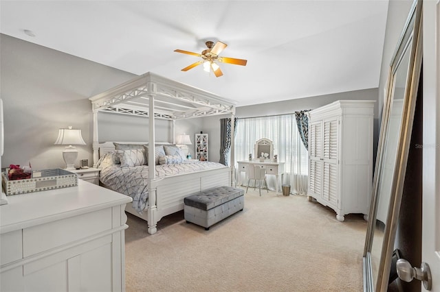 bedroom with light carpet and a ceiling fan