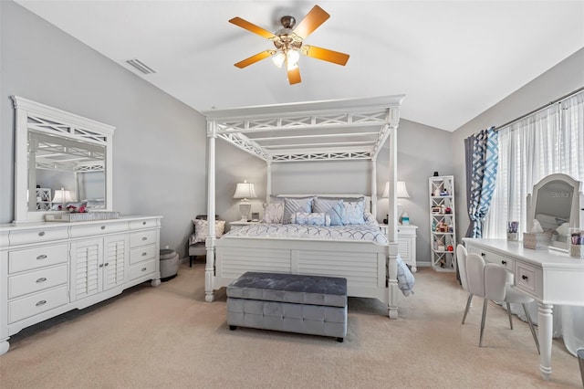 bedroom with light carpet, visible vents, vaulted ceiling, and a ceiling fan