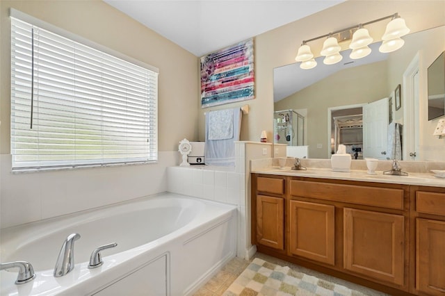 bathroom featuring double vanity, a garden tub, a shower stall, and a sink