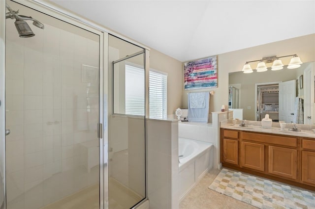 bathroom with a bath, tile patterned flooring, a shower stall, and a sink