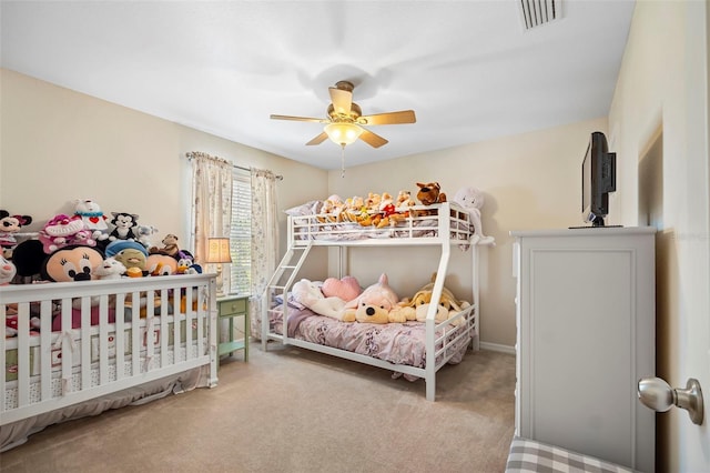 bedroom with carpet, visible vents, and ceiling fan