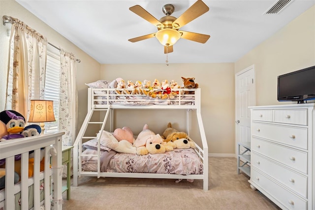 carpeted bedroom featuring baseboards, visible vents, and ceiling fan